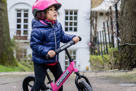 girl riding strider bike