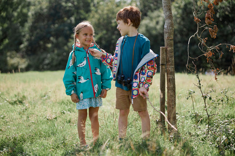 children wearing muddy puddles waterproofs