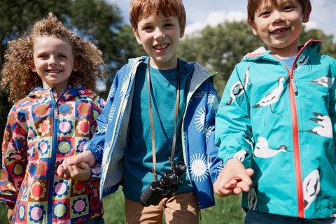 children wearing muddy puddles waterproofs