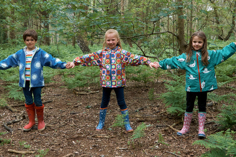 children holding hands in woodland