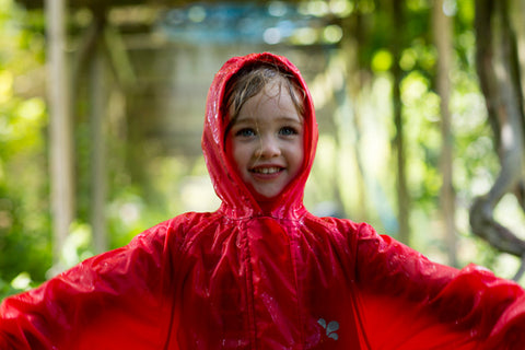 Girl wearing Muddy Puddles waterproofs in the rain