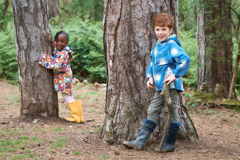 children wearing muddy puddles waterproofs