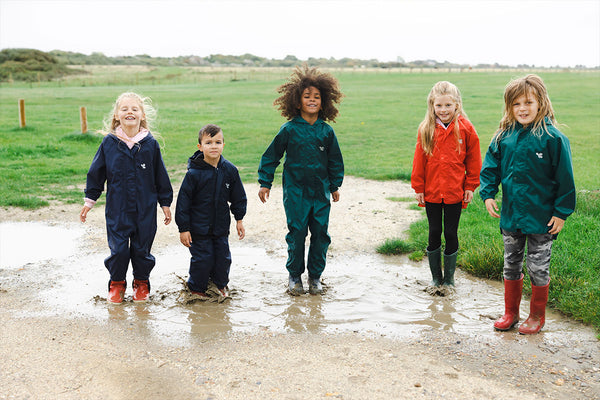 kids jumping in puddles