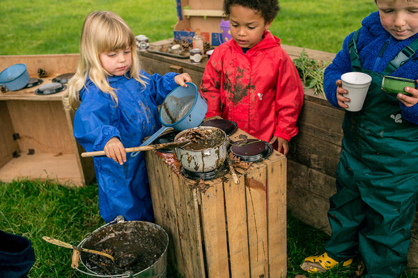 children playing with mud kitchen