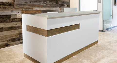 Modern reception desk with reclaimed wood back wall