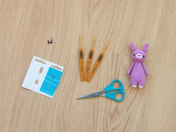 Mini rabbit amigurumi pattern by Little Bear Crochets with crochet supplies.