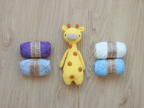 Giraffe amigurumi pattern by Little Bear Crochets with yarn skeins