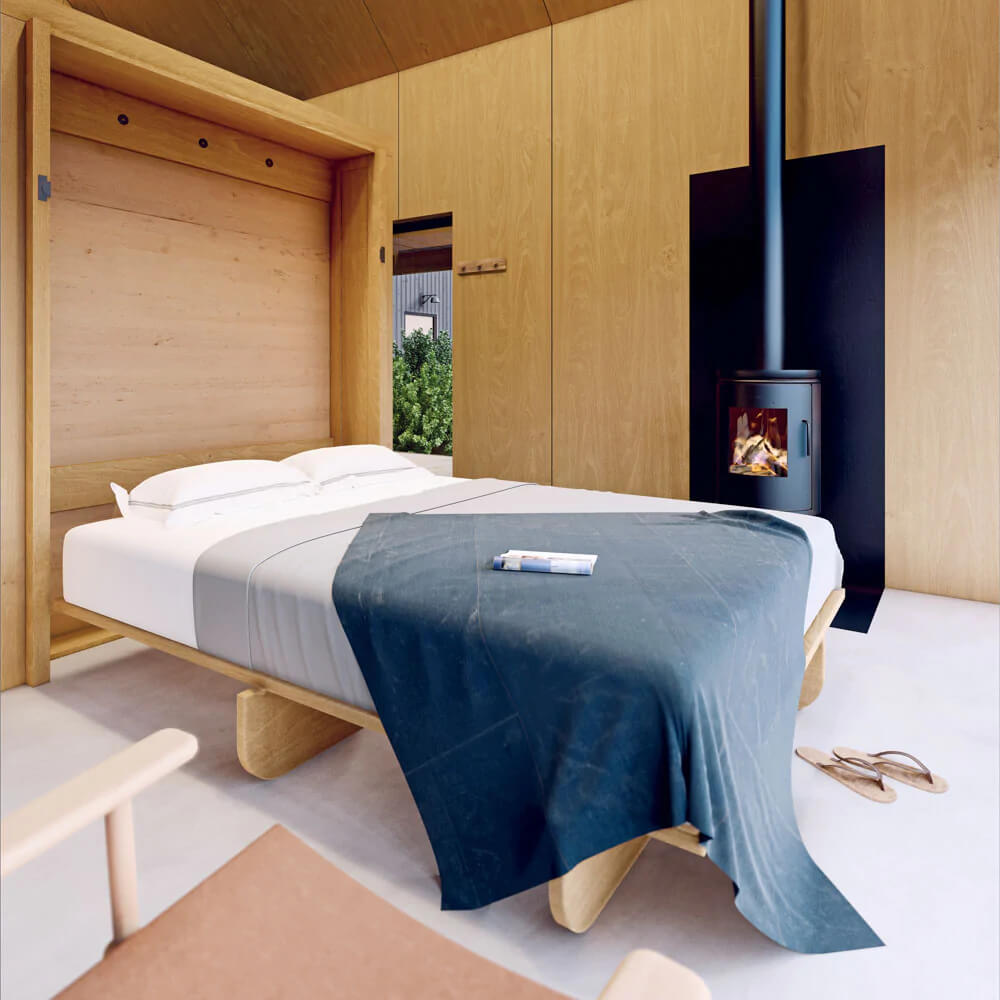DEN's Alpine Tiny Home bedroom with a chimney