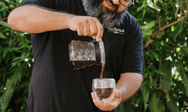 V60 pouring coffee in clear mug