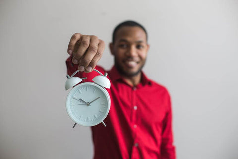 Man Holding Clock