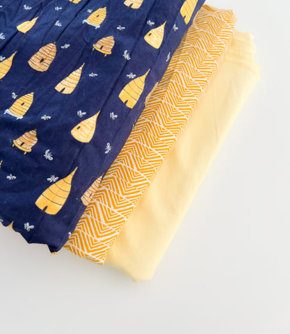 Navy blue and pastel yellow fabric for a baby bib set