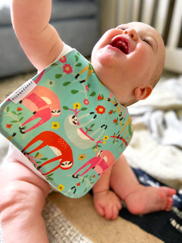 baby wearing a sloth bib in long size