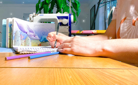 quilted making designs of a quilt at a desk