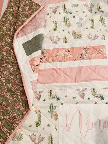 pink binding on baby girl quilt