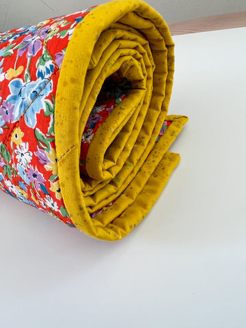 rolled up handmade whole cloth quilt