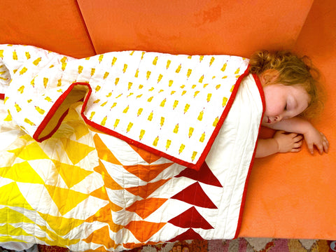 quilt laying on sleeping toddler