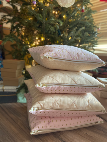 quilted christmas pillows in front of a christmas tree