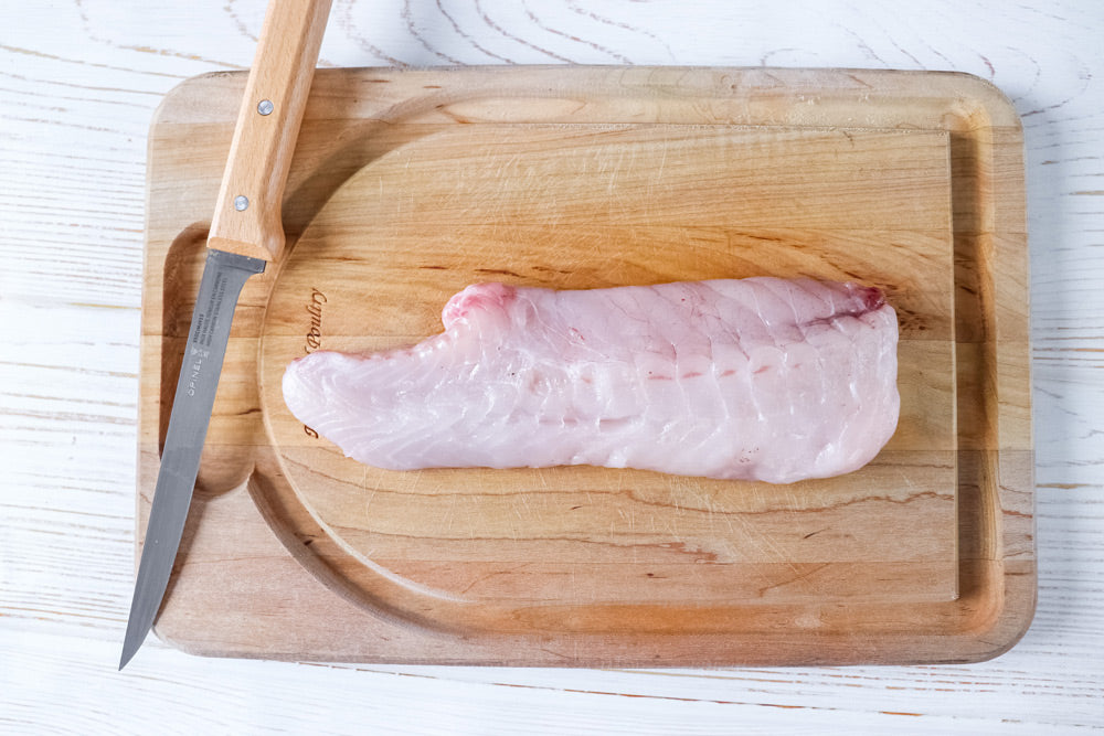 fresh monkfish on cutting board