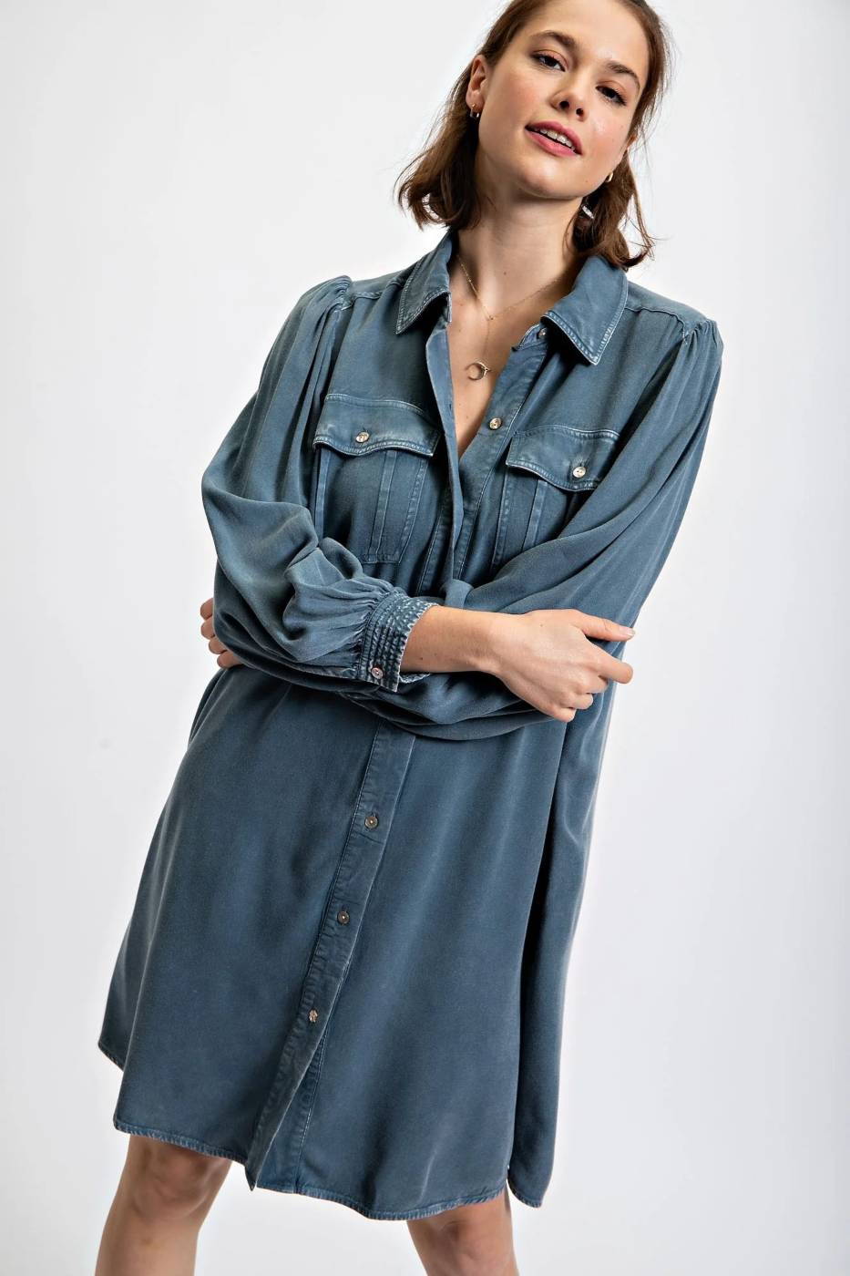 Woman wearing blue denim dress with long sleeves