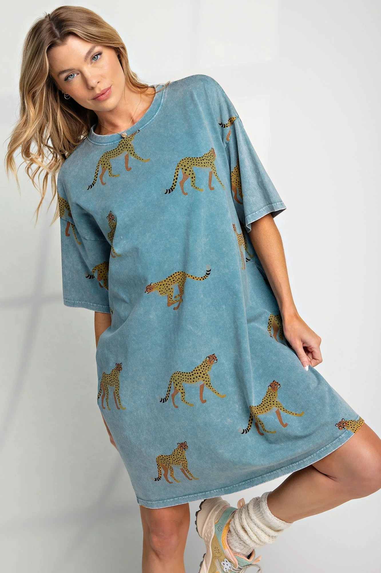 Woman wearing blue dress with cheetahs