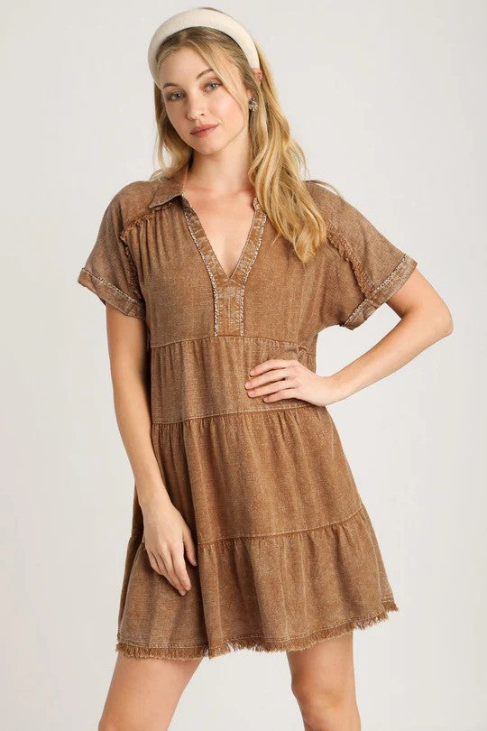 Woman wearing brown tiered summer dress and beige headband