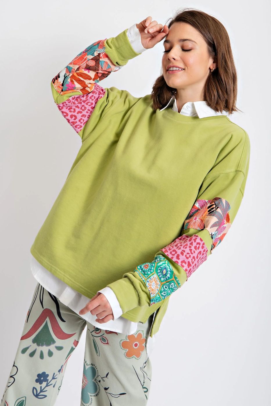 Woman wearing green mixed print full-sleeve top