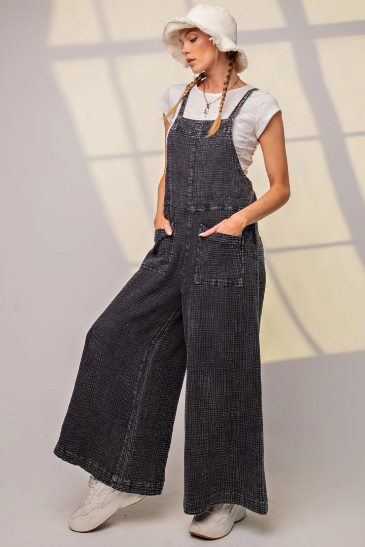 Woman wearing gray overalls