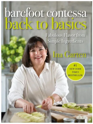 Ina Garten placing apple slices on a piece of puff pastry while looking at the camera