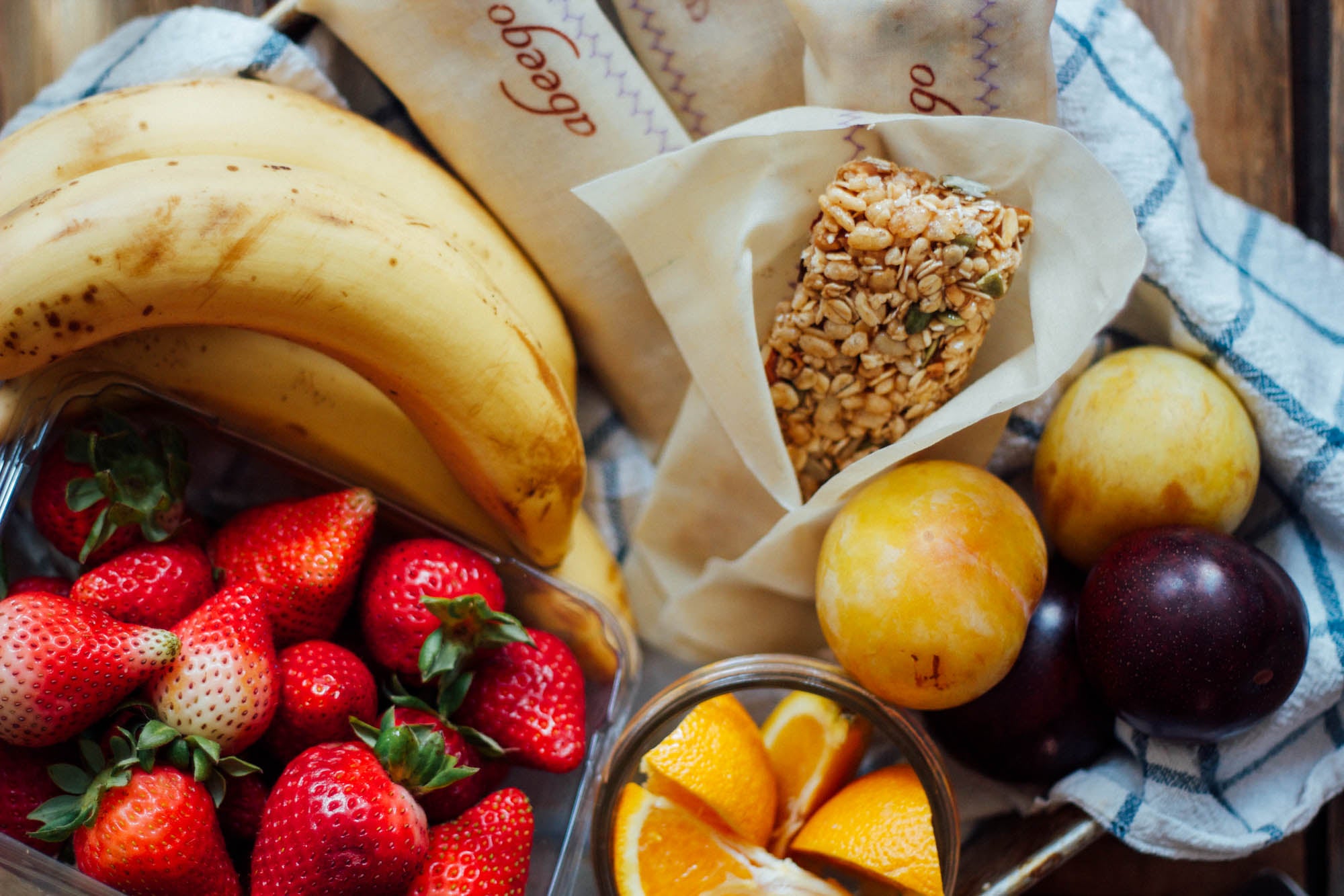 fresh fruit with healthy granola bars wrapped in beeswax wrap