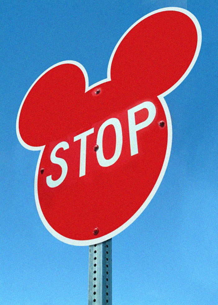 A stop sign shaped like the Mickey Mouse logo