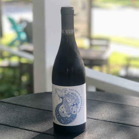 A picture of our Nautical Red wine. the label is a mermaid with lots of Tattoo's to represent both our Oriental and New Bern Community.