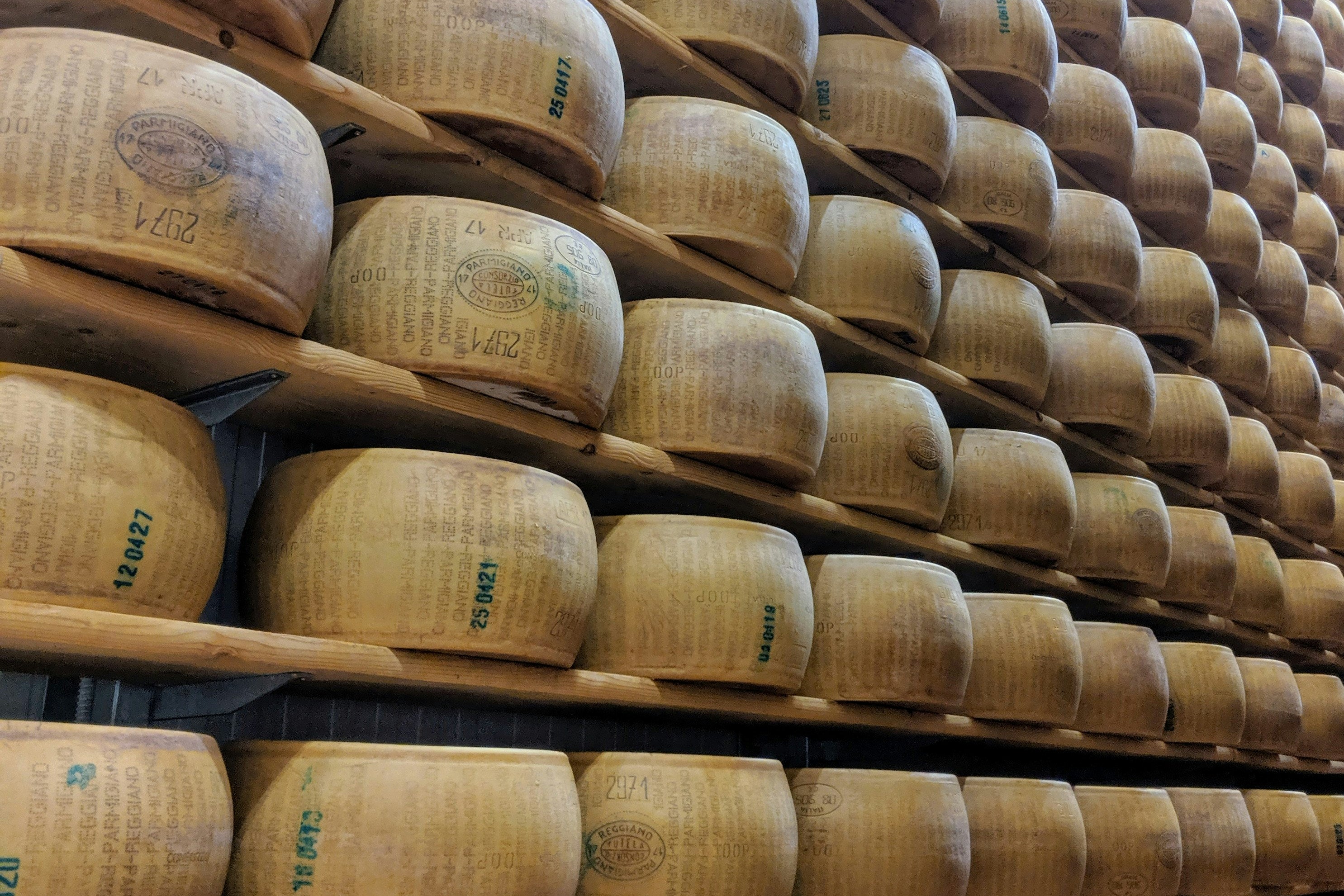 stacked wheels of Parmigiano-Reggiano in the Emilia-Romagna wine region, as featured in the SingleThread Wines wine blog on Italian wines