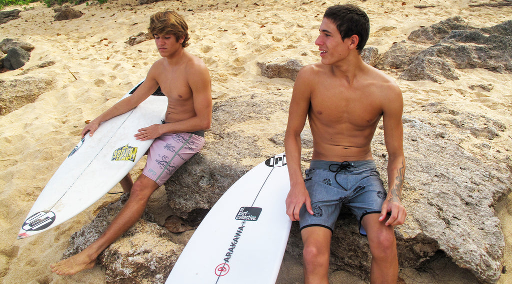 surfers sitting with surfboards