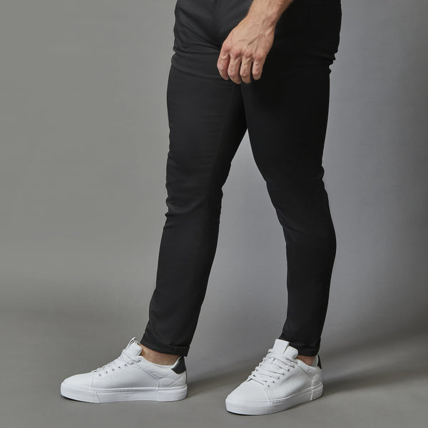 black athletic fit stretch chinos by tapered menswear showing the tapered fit from thigh to ankle