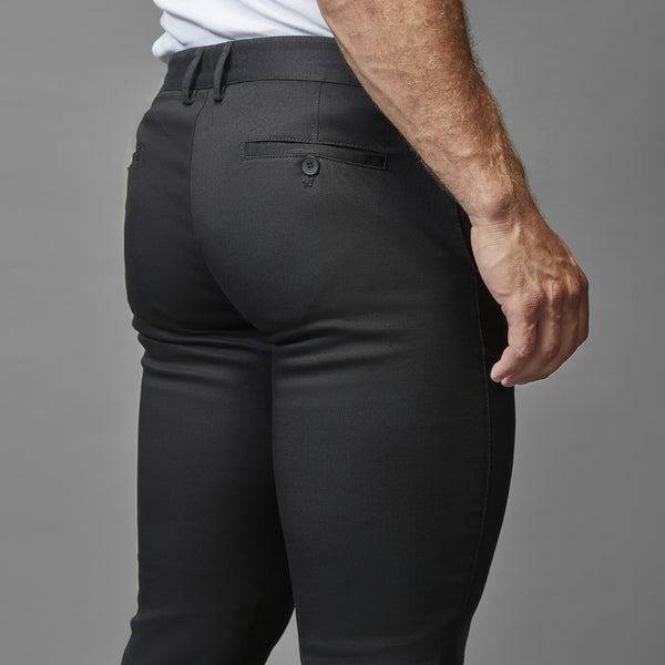 black athletic fit stretch chinos by tapered menswear showing the robust build on muscular legs