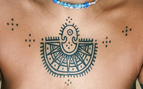 a close up of a tattoo on light brown skin