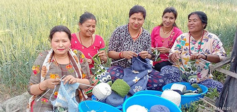 Images shows women knitting items for Pachamama