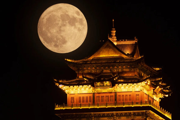 A supermoon rises over a tower in Jiujiang, China, on Tuesday. VCG via Getty Images