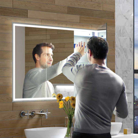 Man using bathroom mirror with storage in small bathroom