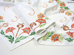 This linen tablecloth is hand painted with the Poppy Stencil by Sproule Studios.