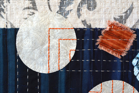 Hand stitching paper to fabric by April Sproule