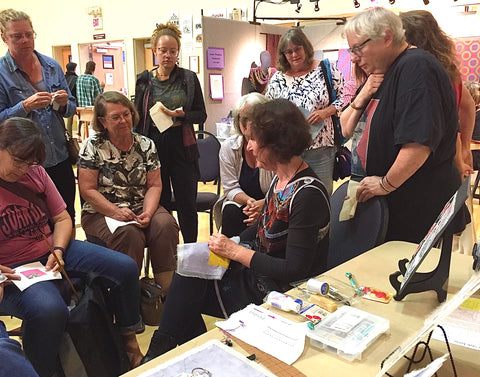 April Sproule giving a demo at a textile event.