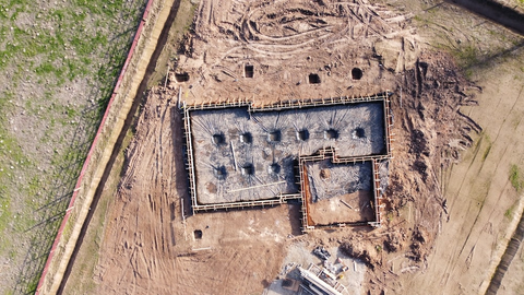 A small lean-to greenhouse foundation prep aerial view