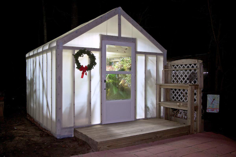 A greenhouse on a raised wooden base