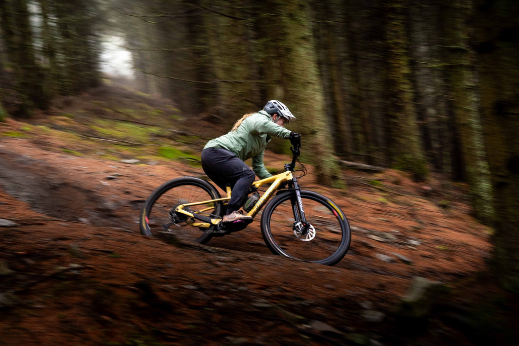 Fi riding a left hand turn on Green Wing, a technical enduro trail, on her Wilder