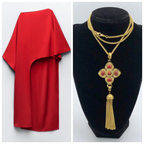 Zara red asymmetrical top and a long skirt. A long chain necklace with a cross pendant with red gemstones and a tassel.