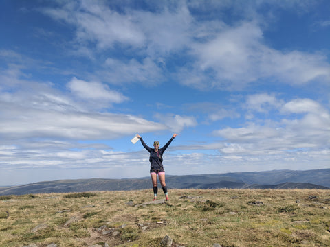 FOHER Co Ambassador Philadelphia Holmes standing on the top of Mt Bogong on a 50km run in the Victorian High Country.