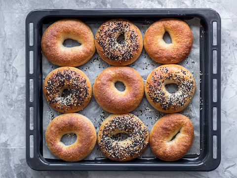 Plain and Everything bagels on a baking tray