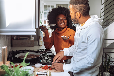 Couple cooking together in the kitchen