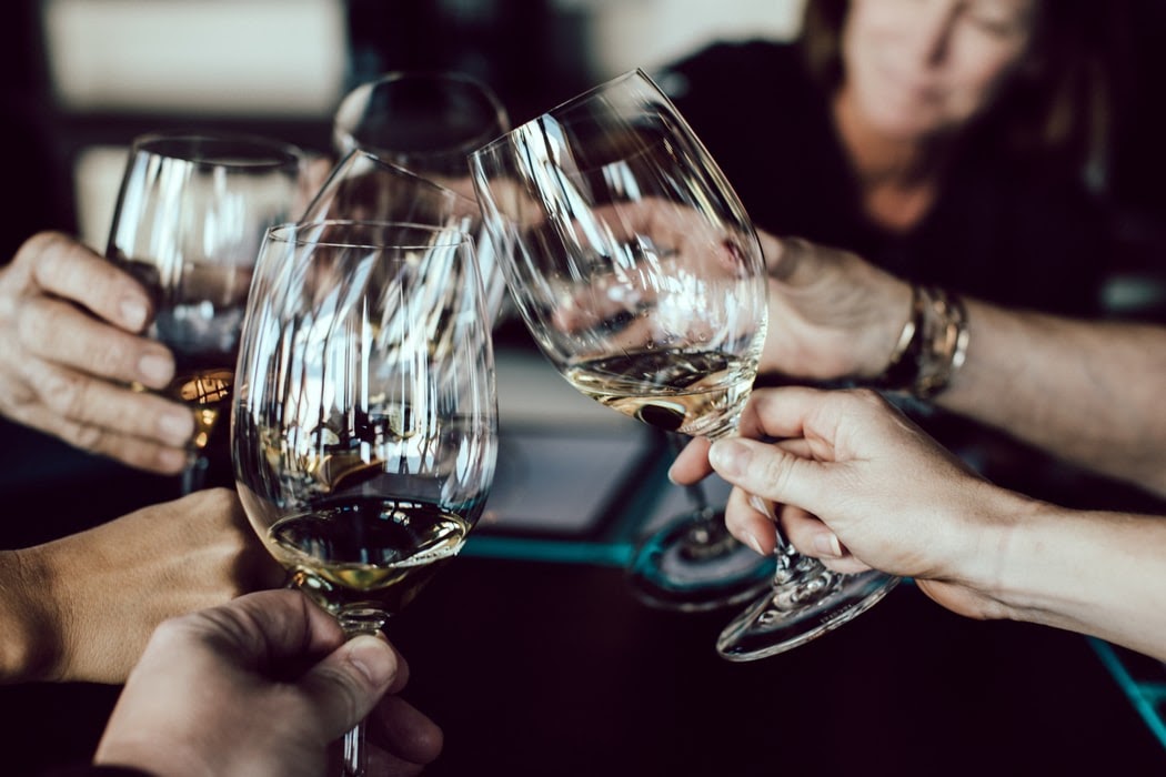 A group of people clinking wine glasses